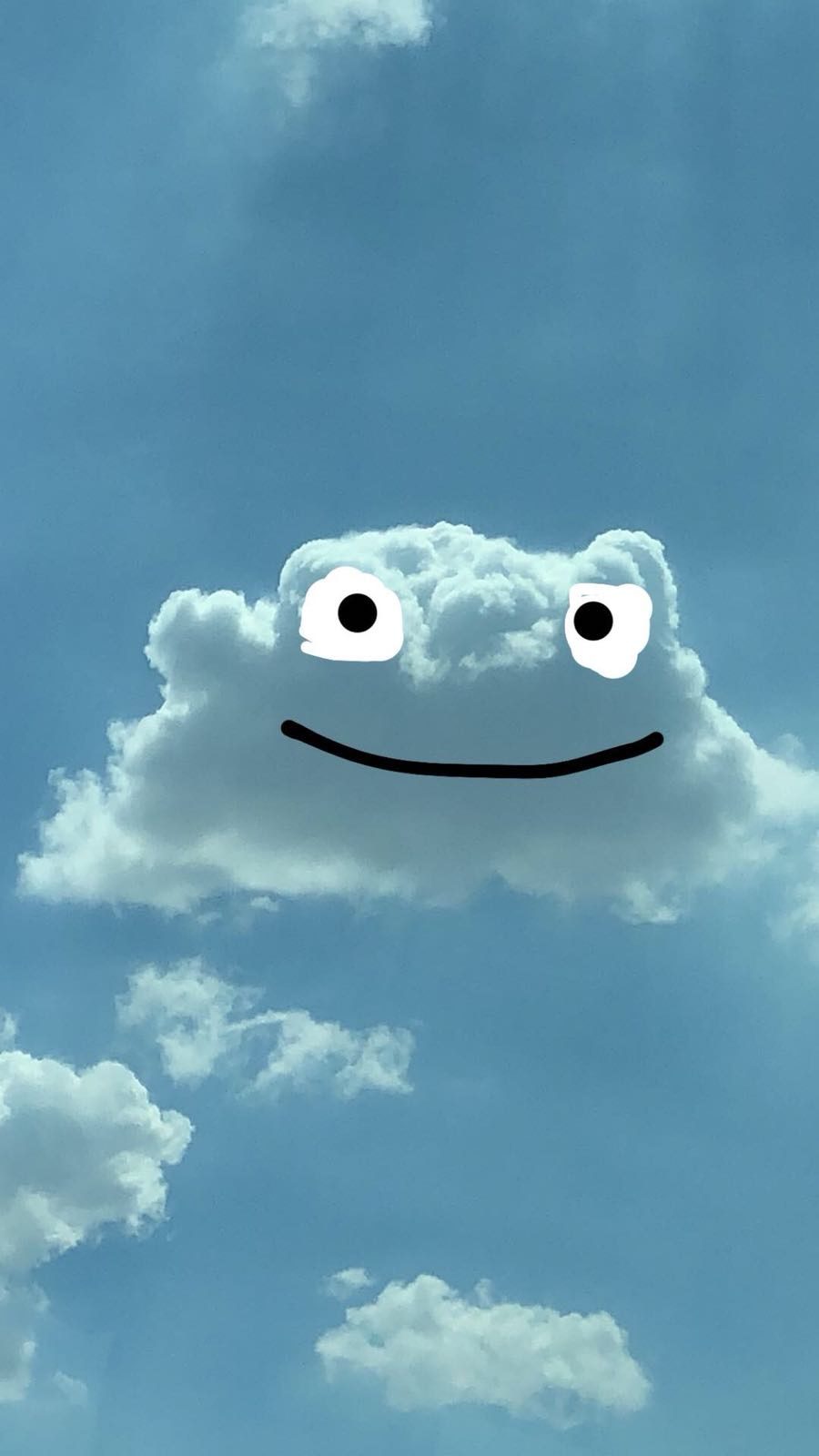 A cloud with drawn-on eyes and a smile
