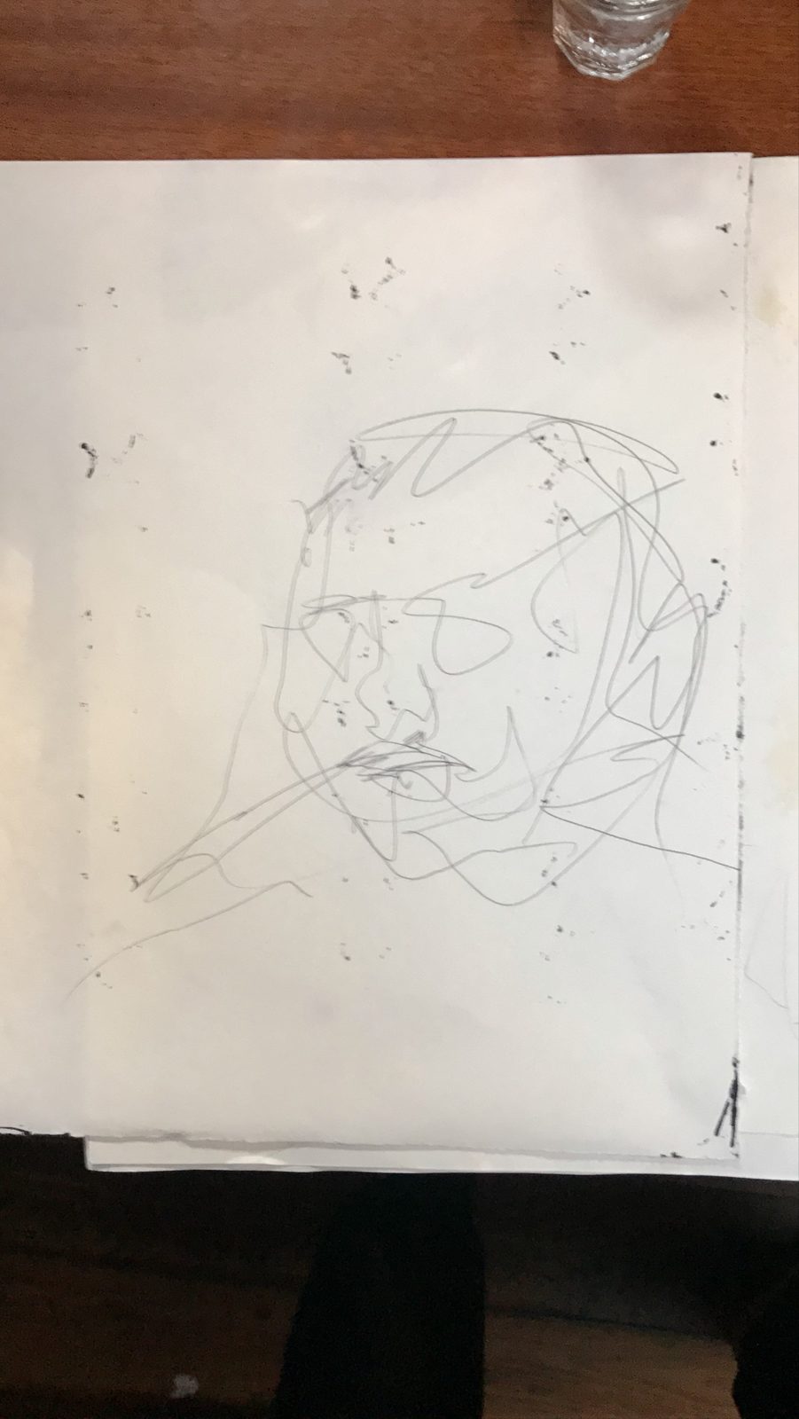 A face drawn in one loose wandering line