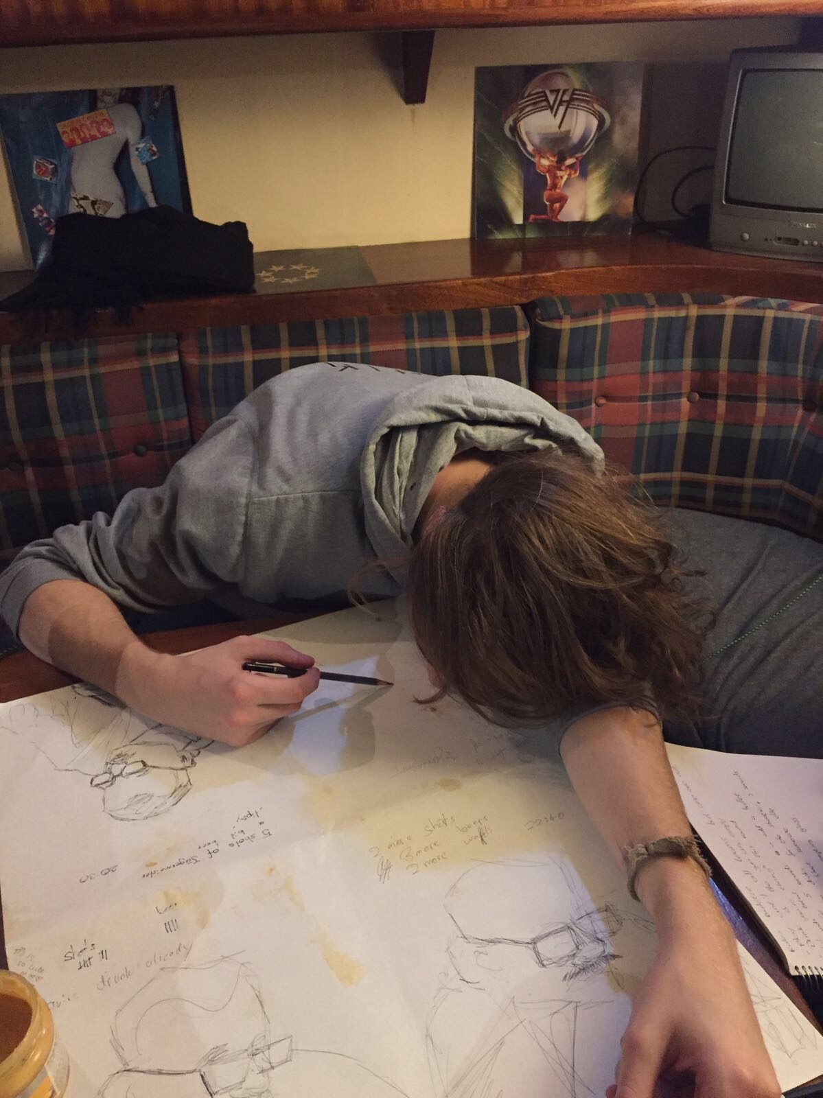 Photo: me asleep on the table on top of the drawings, pencil still in hand