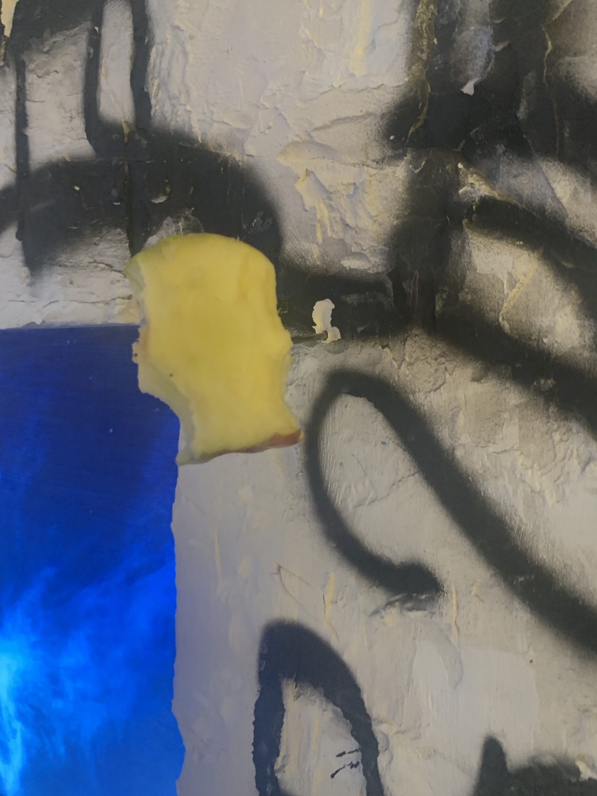 Detail: an apple core nailed into the plaster next to the painting