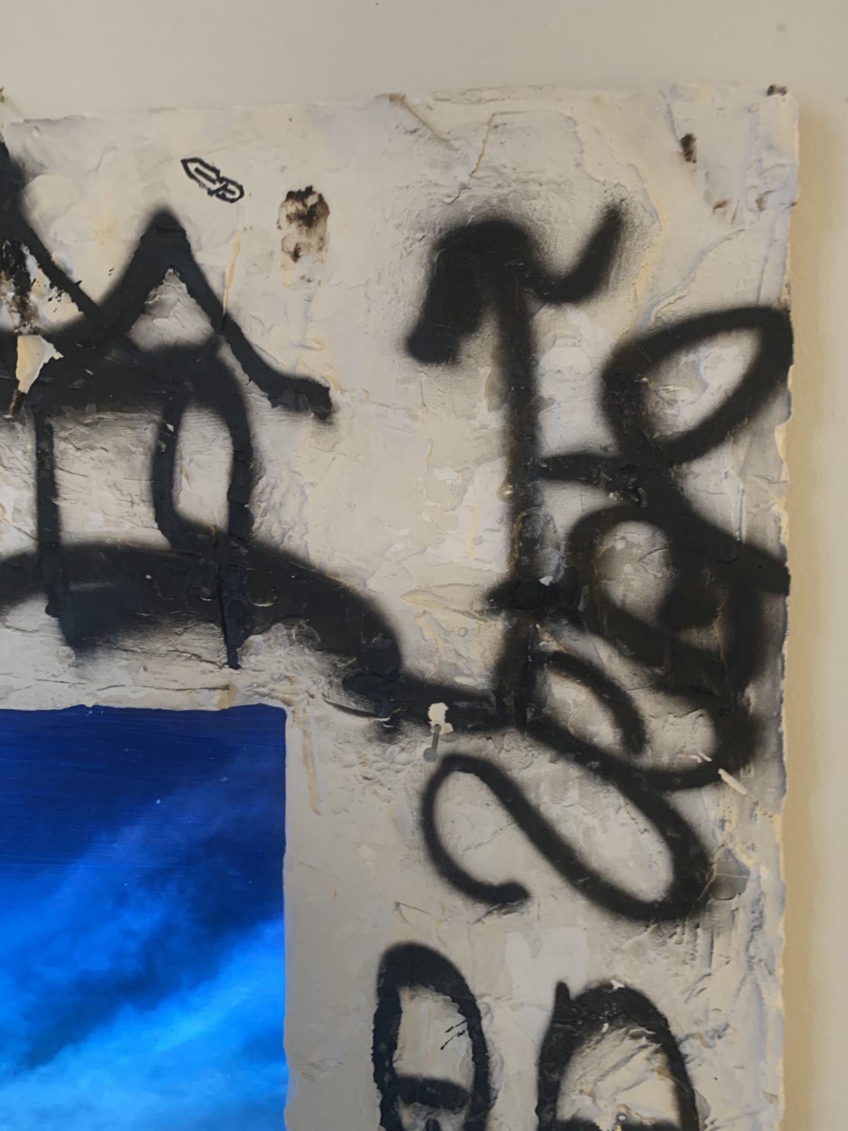 Detail: black spray tags in the top right corner
