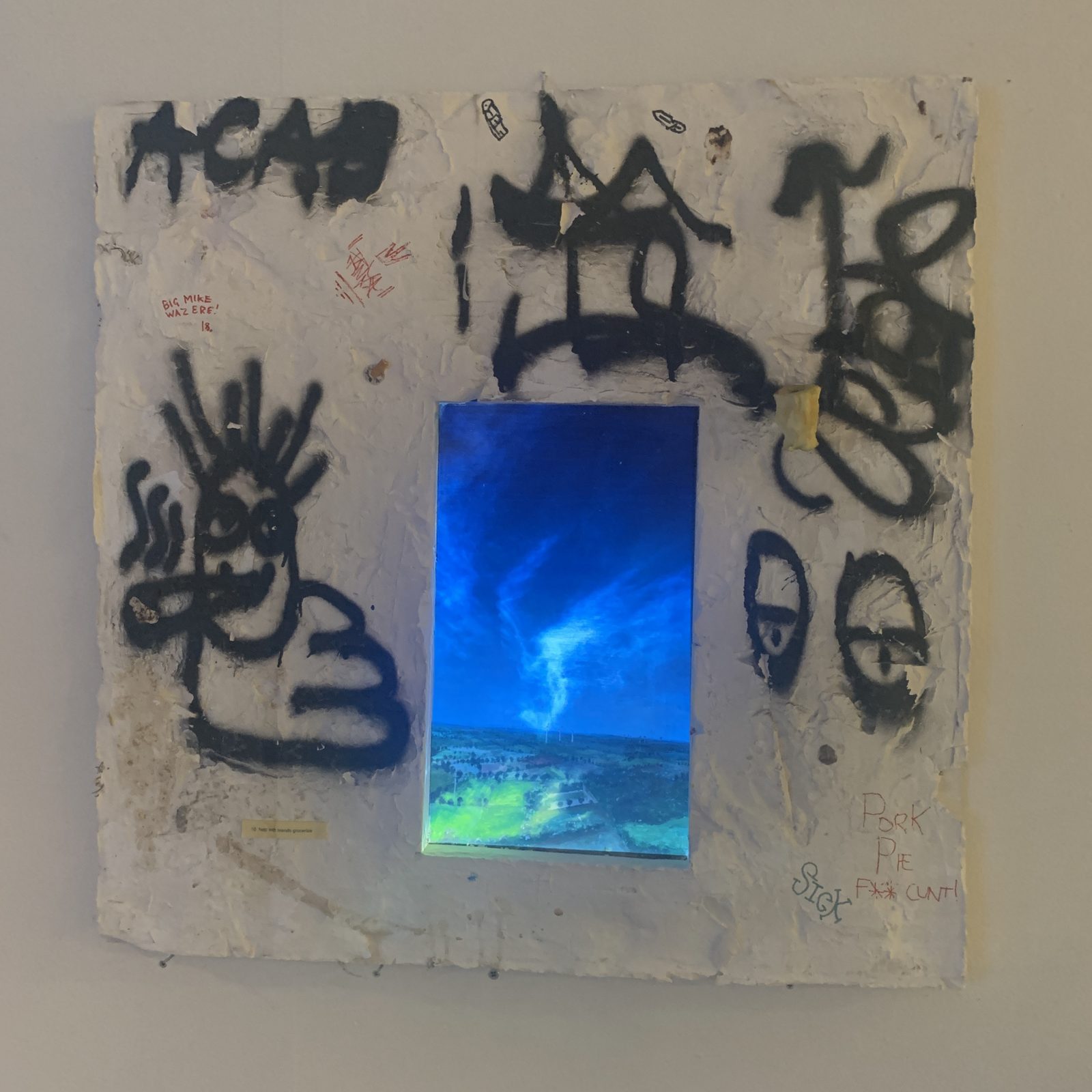 A white cloud projected into the sky of the painting in the hole