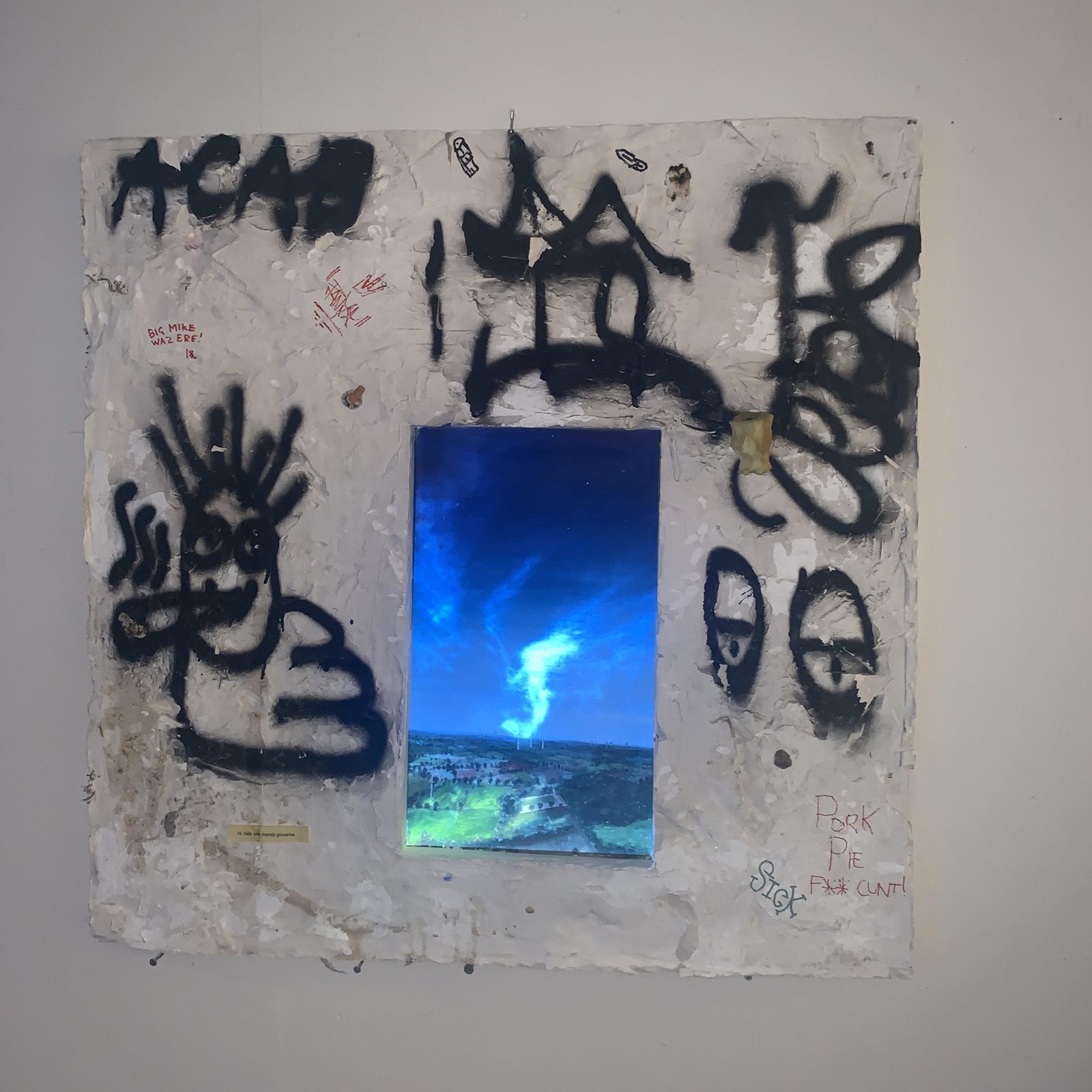 Clouds projected onto the painting, the graffiti around it