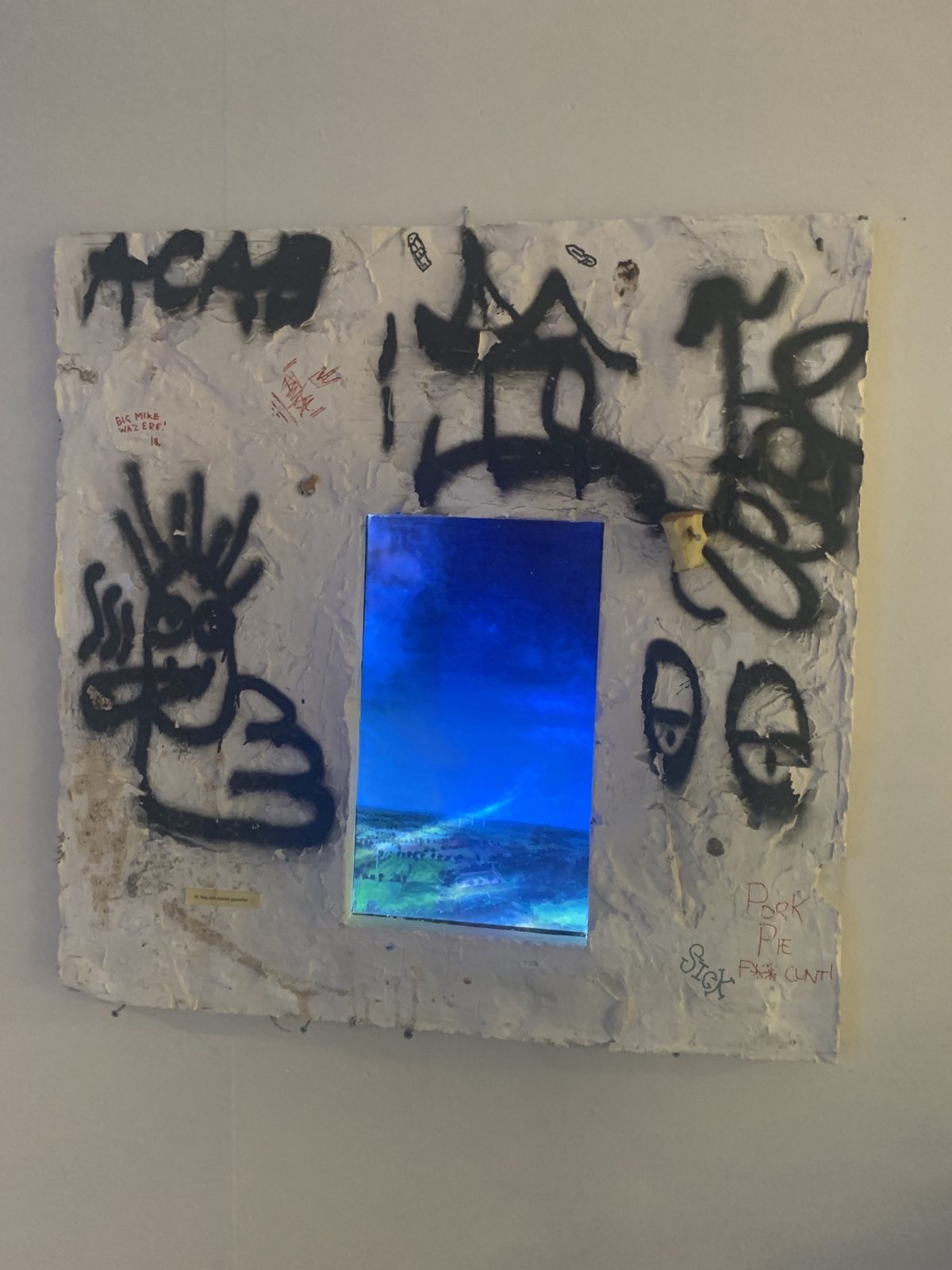 The wall in dim light, the projection glowing blue