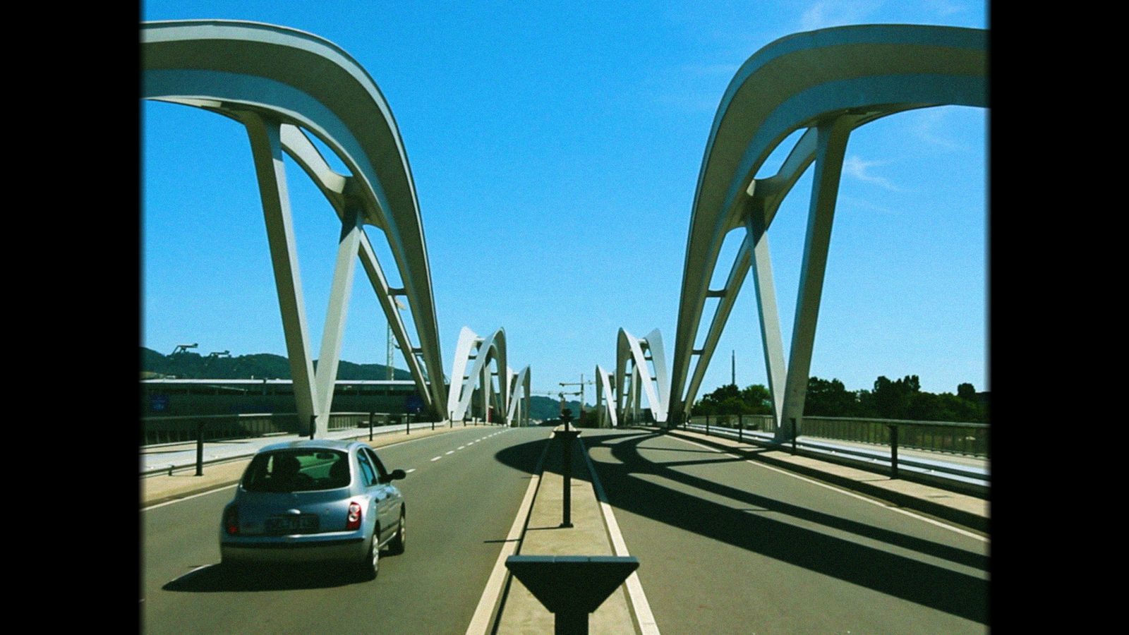 Pareidolia: a car on a bridge with white arches